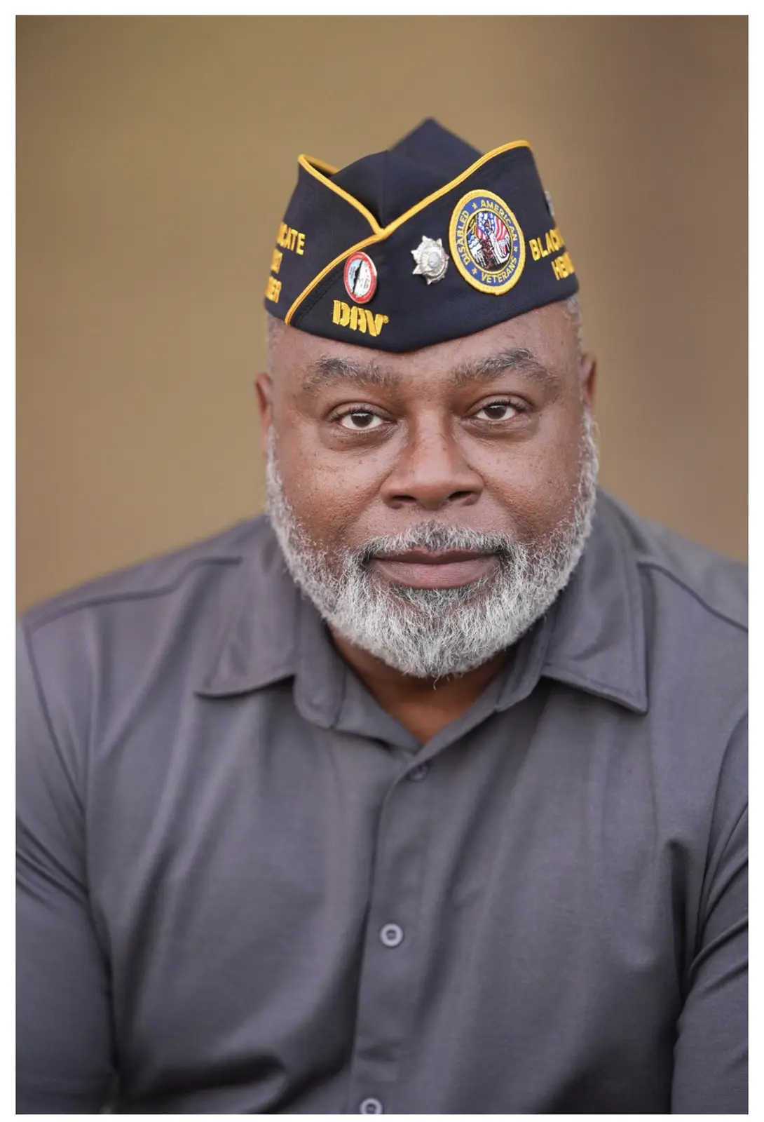Portrait of Christopher Smith in his DAV garrison cap and gray shirt.