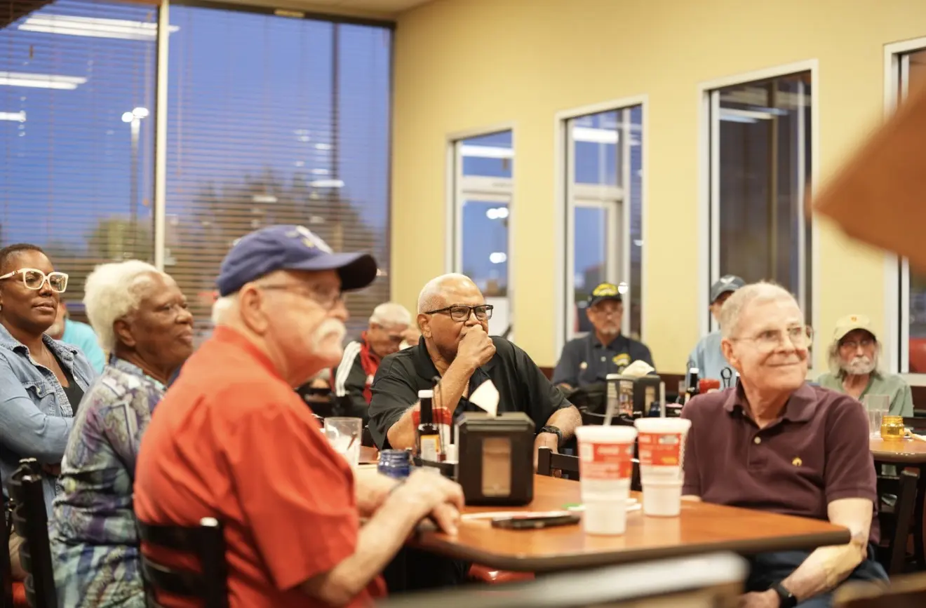 Members seated around the tables at Golden Corral in Henderson, listening to reports.