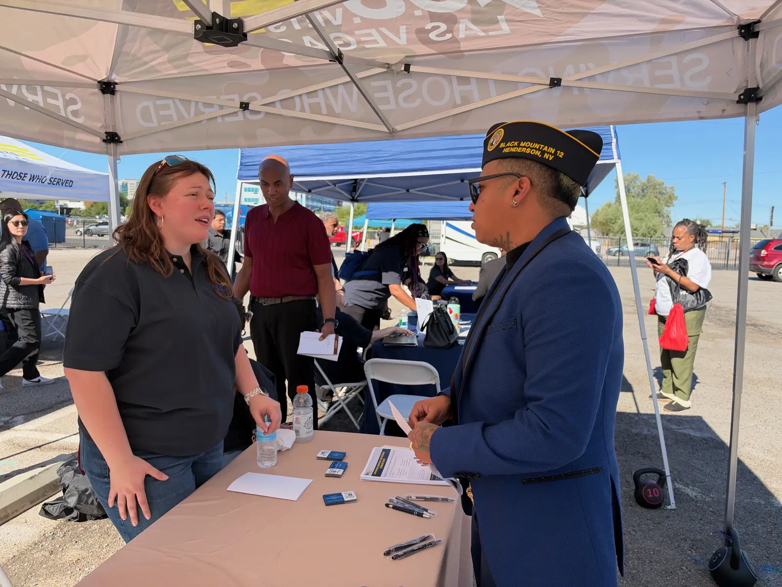 Lukas Serrano visits a table under a U.S.VETS Las Vegas canopy as Veterans and supporters browse the resource tents.