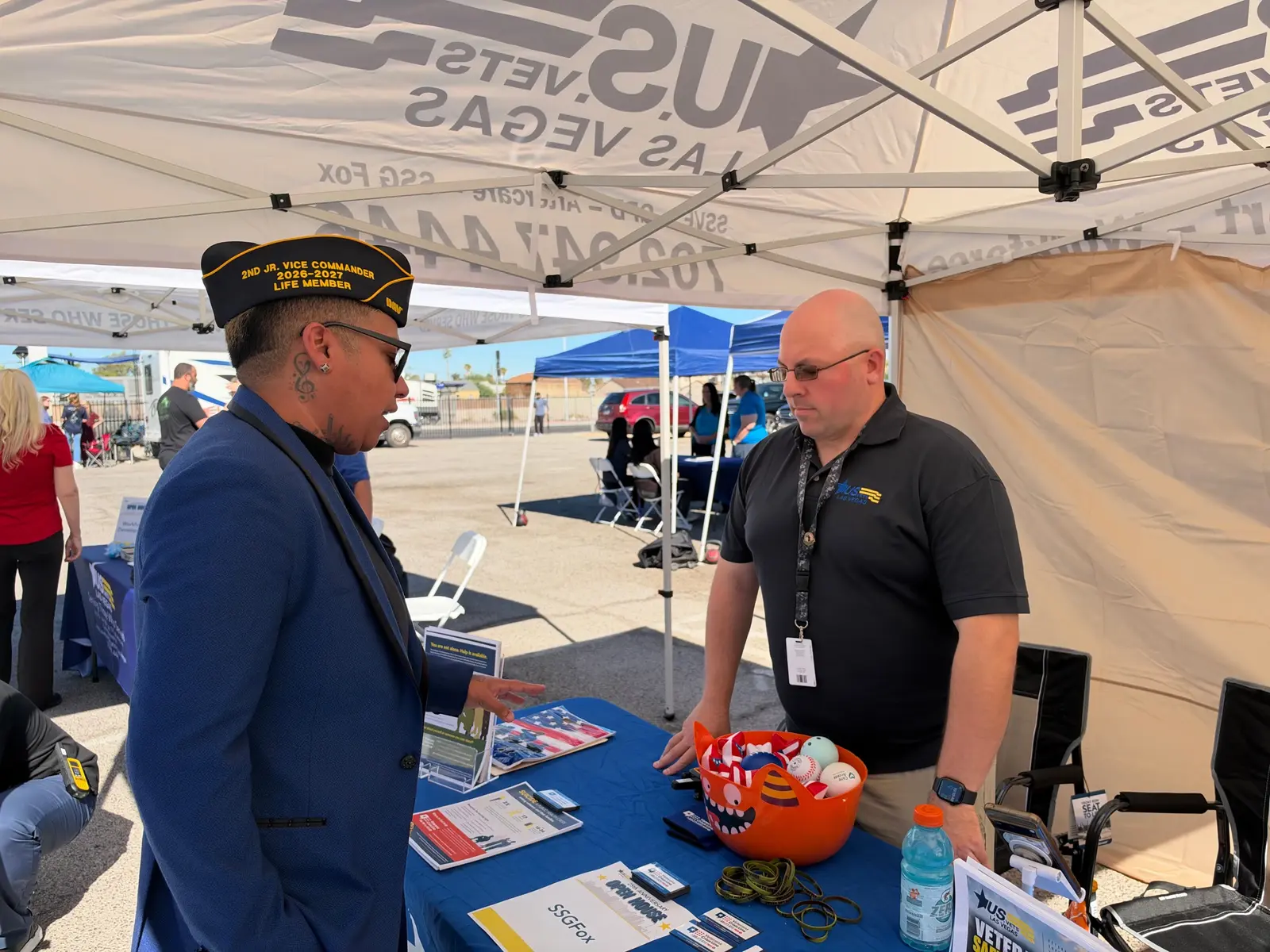 Lukas Serrano talks with a representative at a U.S.VETS Las Vegas information table.